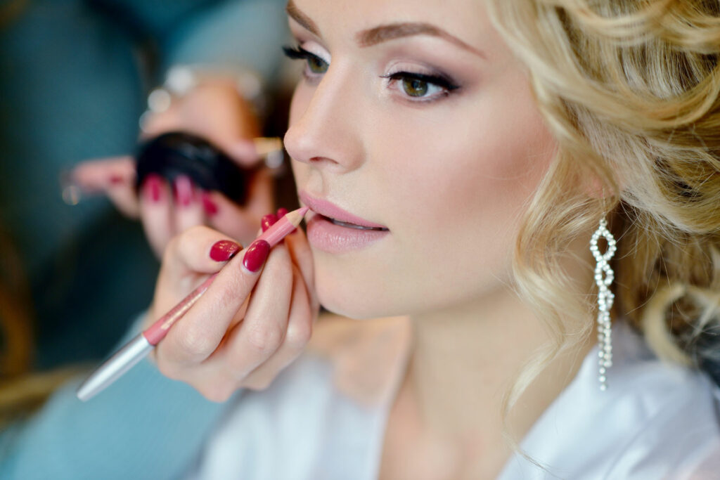 Wedding makeup artist making a make up for bride. Beautiful sexy